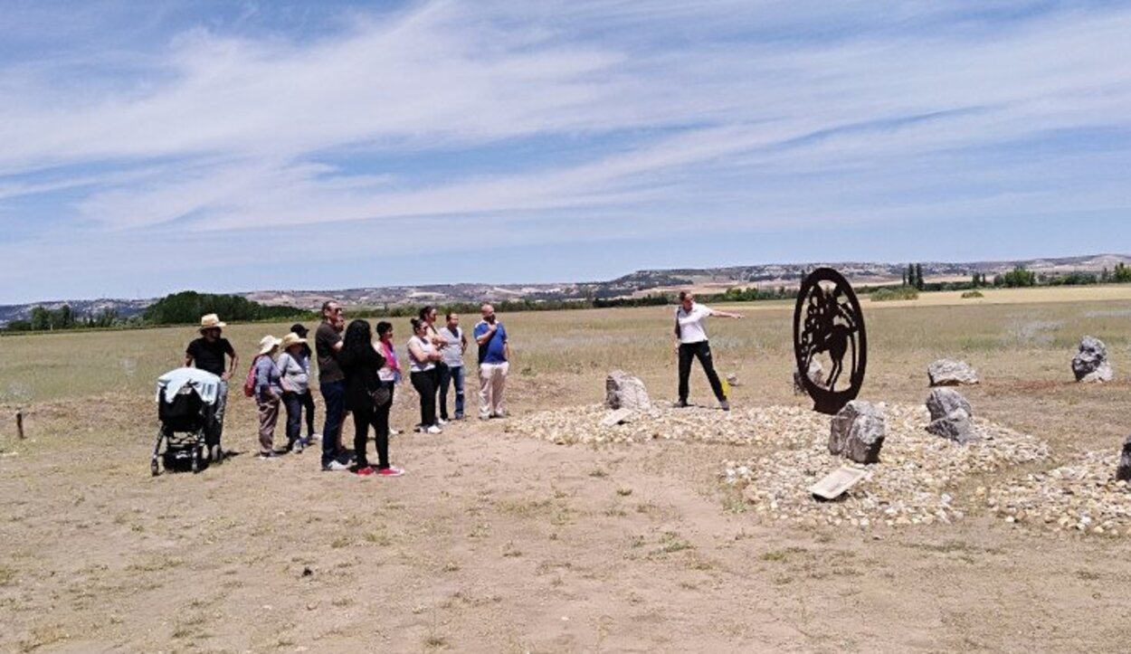 Visitantes junto a una arqueóloga en la necrópolis de Las Ruedas